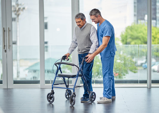 Shot of a nurse helping a senior man with a Rollator.