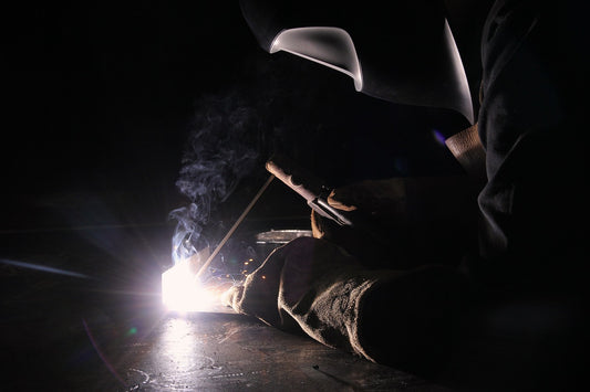 A welder with welding helmet