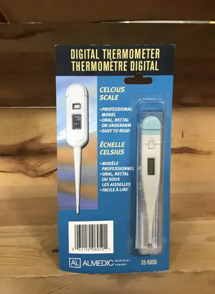 Digital thermometer packaging with Celsius scale on a wooden surface